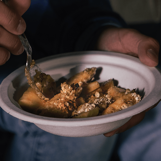 Eating apple crisp out of a Chinet Classic® Bowl
