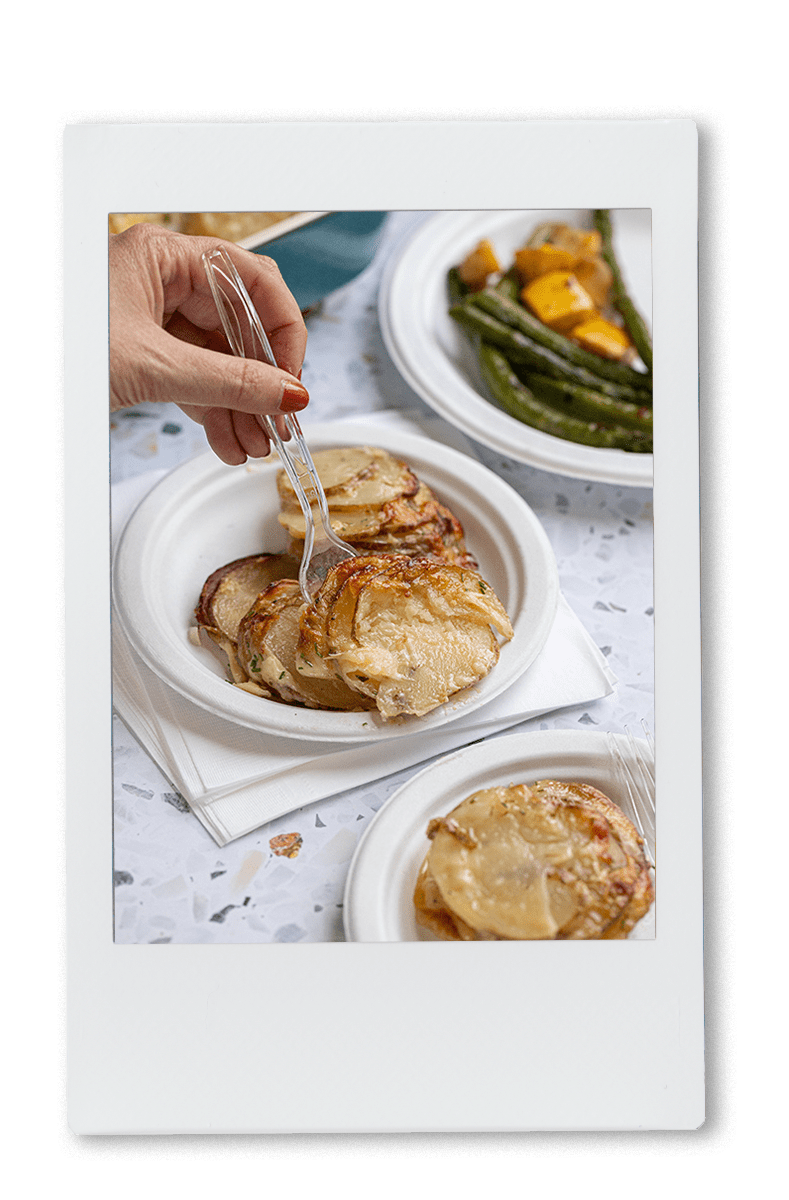 Cheesy Hassleback potatoes served on a Chinet Classic plate