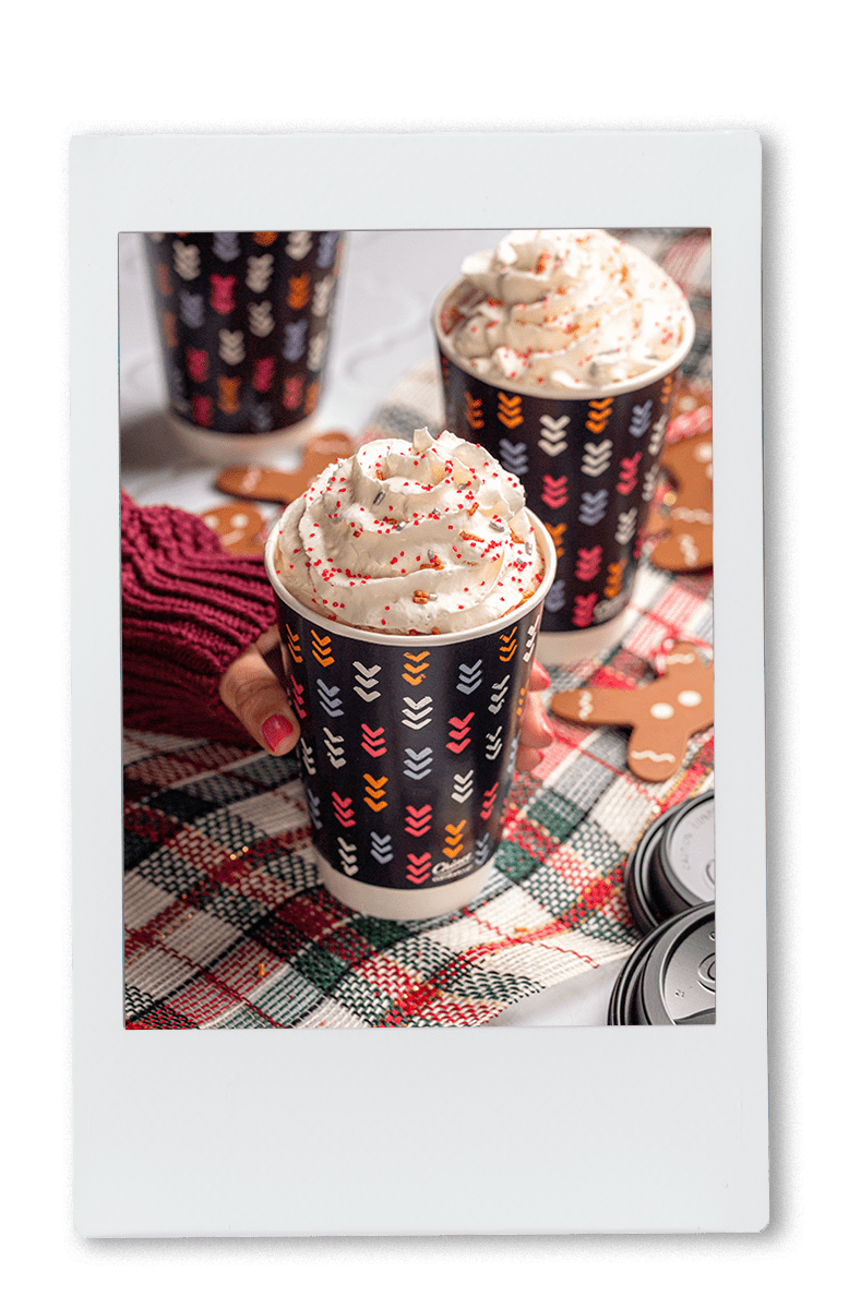Instax picture of gingerbread lattes served in Chinet Comfort Cups with whipped cream on top