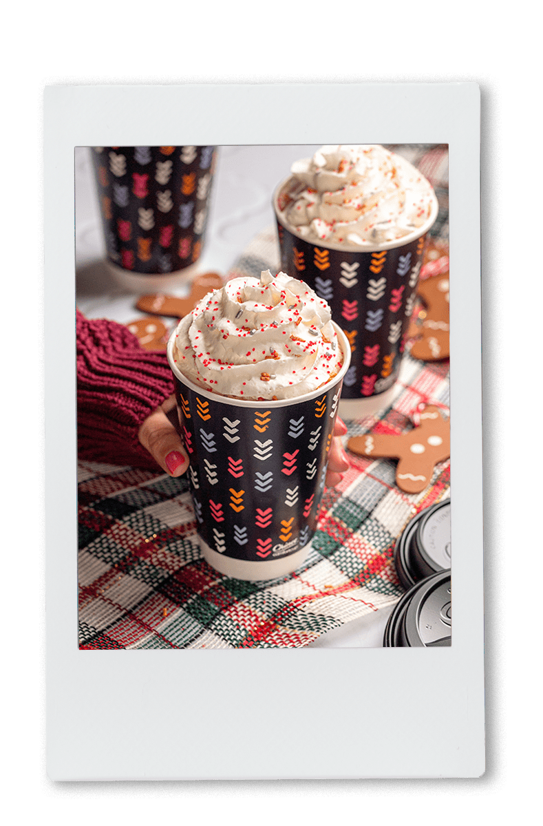 Instax picture of gingerbread lattes served in Chinet Comfort Cups with whipped cream on top