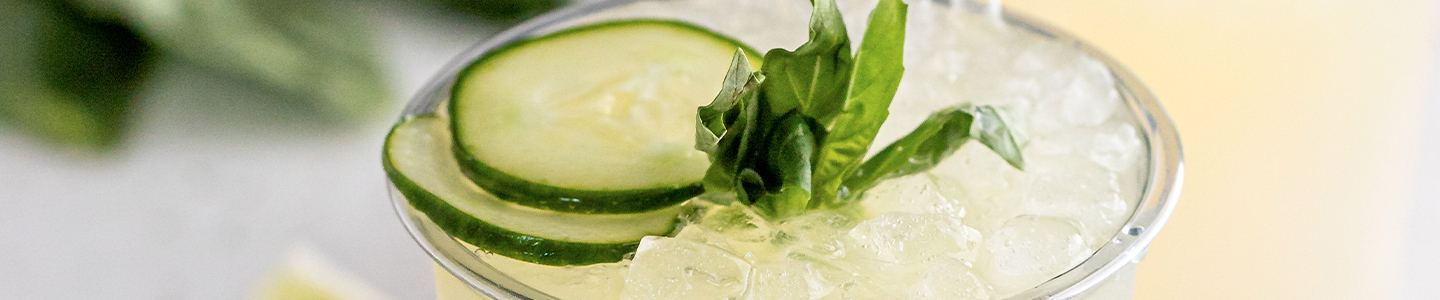 Sliced cucumber topping on a mocktail beverage