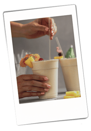 Instax picture of hands stirring a pina colada served in a Chinet Classic Recycled Clear Cup
