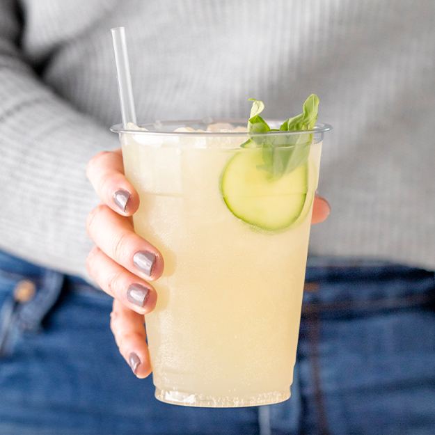 Women holding a cucumber basil refresher served in a Chinet Classic Recycled Clear cup