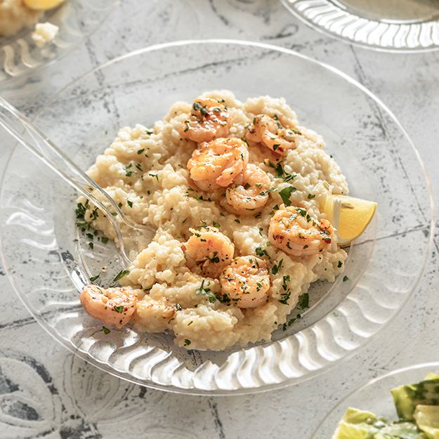 Baked parmesan risotto with lemon garlic shrimp served on Chinet Crystal plate