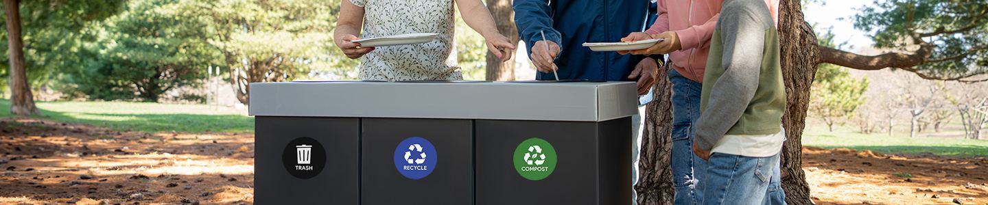 Family throwing away plates and food at a picnic