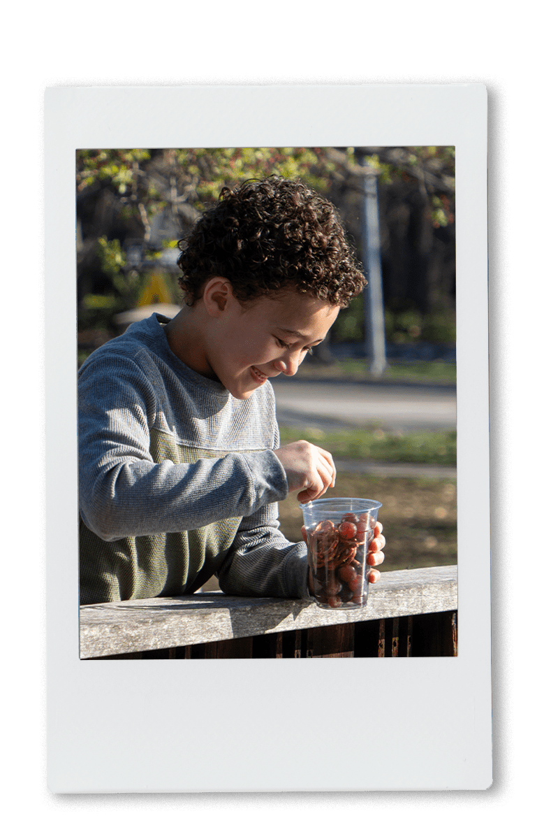 Kid eating snacks out of chinet R-Pet cup