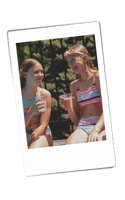 Instax of of two girls drinking the Strawberry-Peach Smoothie in a Chinet cup