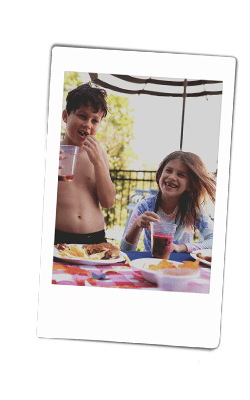 Instax of kids laughing at a pool party with chinet products