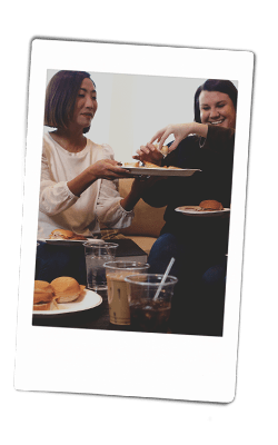 Instax picture of women passing food