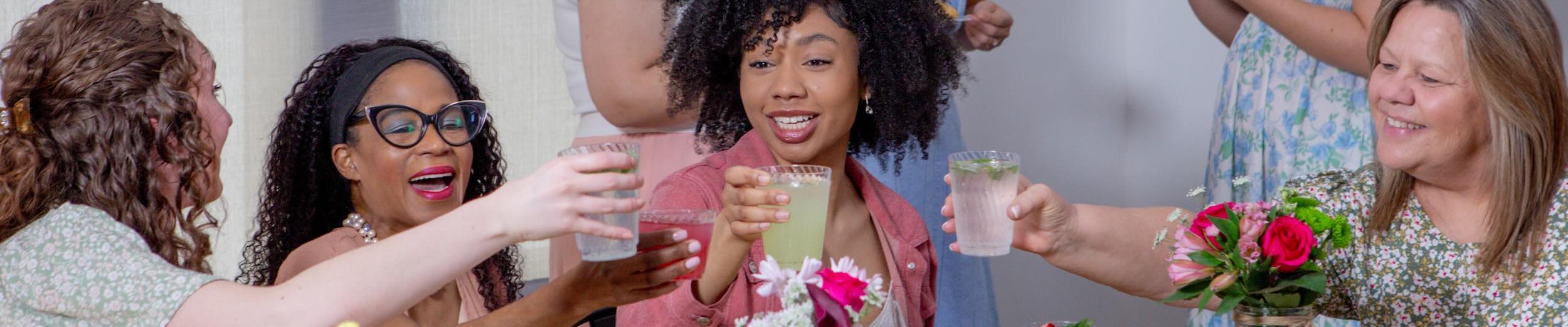 Women toast drinks in Chinet Crystal cups at a spring brunch