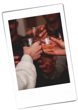 Group of hands holding up Chinet Crystal cups to cheers