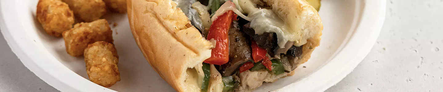 Chicken and mushroom cheesesteak served on a Chinet Classic plate