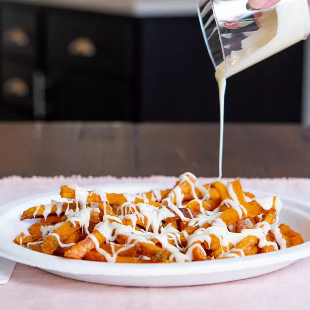 Icing drizzled over sweet potato french fries