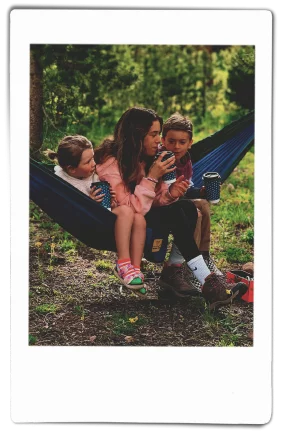 Woman and children sitting in a hammock holding Chinet Comfort® Cups