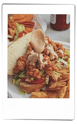 Instax picture of a crawfish po boy served on a Chinet Classic plate