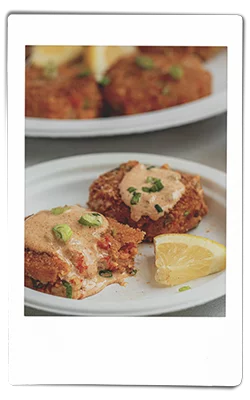 Instax picture of a crawfish cakes served on a Chinet Classic plate