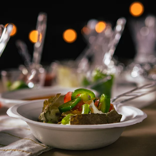 Fully loaded baked potato in a Chinet classic bowl