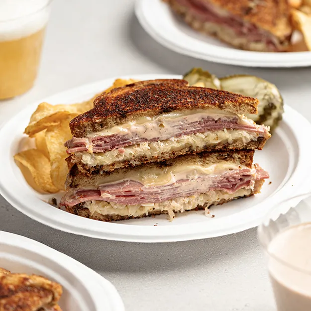 Reuben grilled cheese sandwich served on Chinet Classic plates