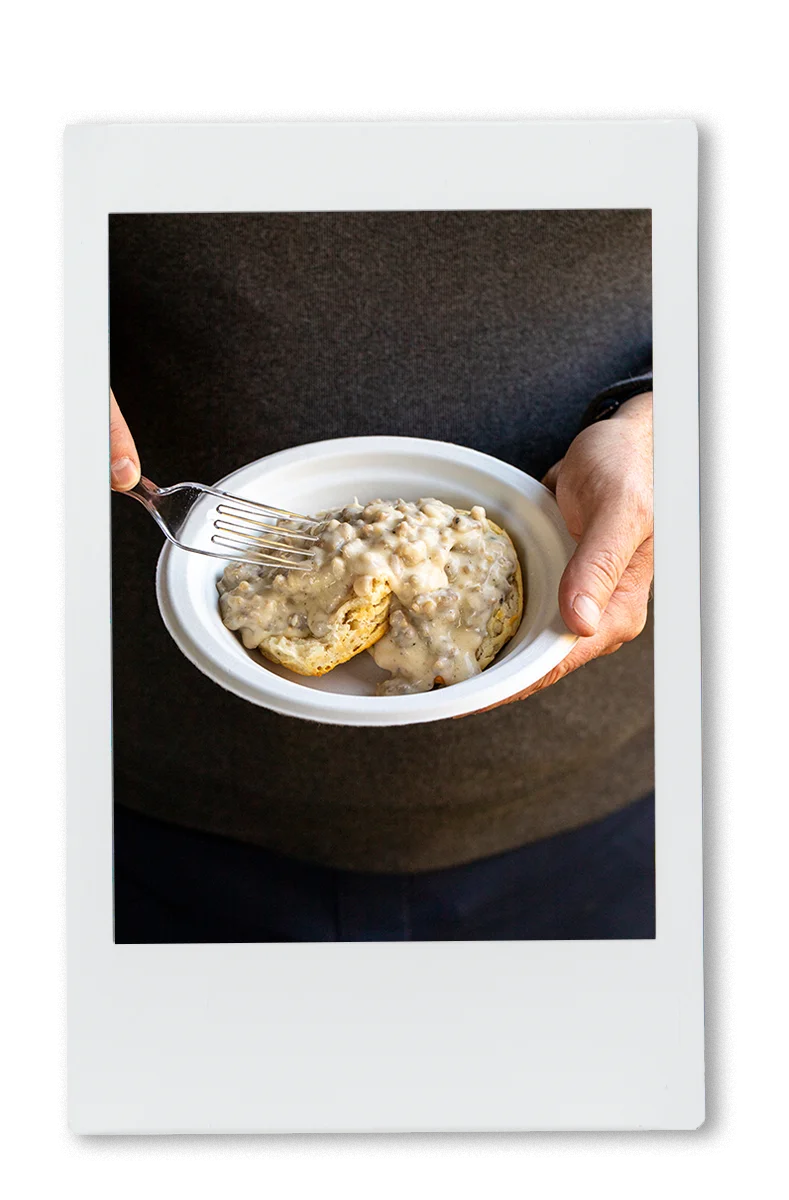 Instax of man eating biscuits and gravy