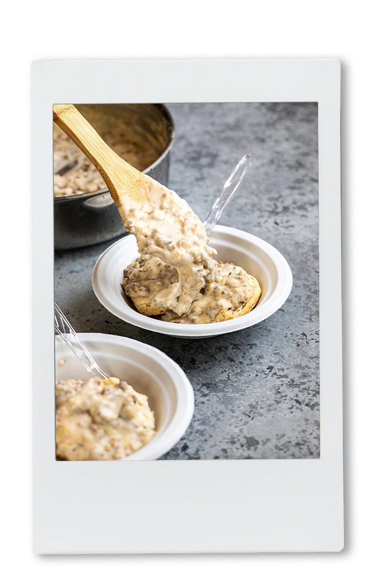 Instax of sausage and gravy being added to biscuits